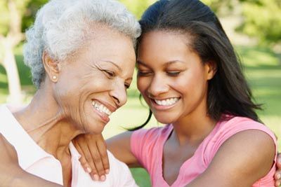 mom smiling with her daughter after getting dentures