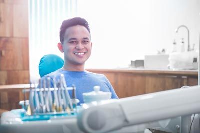 man smiling after having his teeth treated for sensitivity